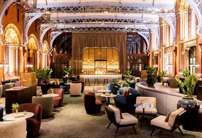 Interior of the gay-friendly St. Pancras Renaissance Hotel in London. A bar and lounge area with comfortable seating. Elegant design.
