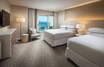 Sheraton Waikiki Beach Resort: Gay-friendly hotel room with two beds, balcony overlooking the ocean. Ideal for gay men's travel.