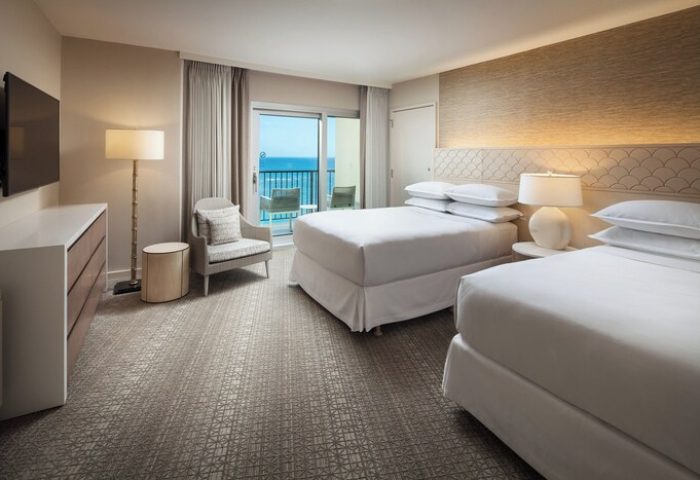 Sheraton Waikiki Beach Resort: Gay-friendly hotel room with two beds, balcony overlooking the ocean. Ideal for gay men's travel.