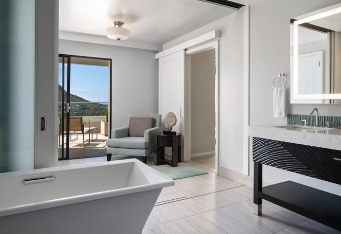 Moana Surfrider, Waikiki Beach gay-friendly hotel room. Bathtub, chair, and balcony with a view. Westin Resort & Spa bathroom.