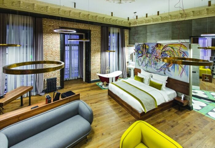 Hotel The Public Special Category: Gay-friendly hotel room with a bed, sofa, bathtub, and modern design. Ideal for gay men's travel.