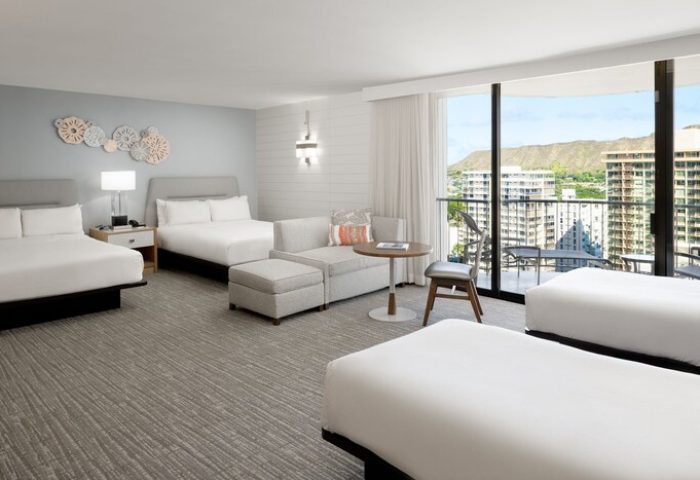 Waikiki Beach Marriott Resort & Spa: Gay-friendly hotel room with beds, seating area, balcony, and city view. Ideal for gay men's travel.