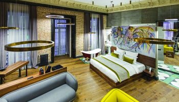 Hotel The Public Special Category: Gay-friendly hotel room with a bed, sofa, bathtub, and modern design. Ideal for gay men's travel.