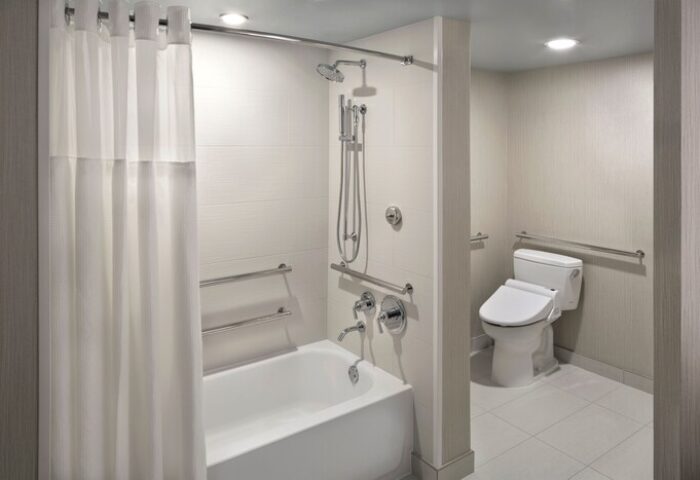 Hyatt Regency Waikiki Beach Resort & Spa gay-friendly hotel bathroom. Accessible bathtub, shower, and toilet with grab bars.