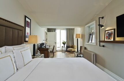 The Bank Hotel Istanbul room. Gay-friendly Design Hotel™ features a bed, desk, and balcony. Ideal for gay travel, offering a stylish stay.