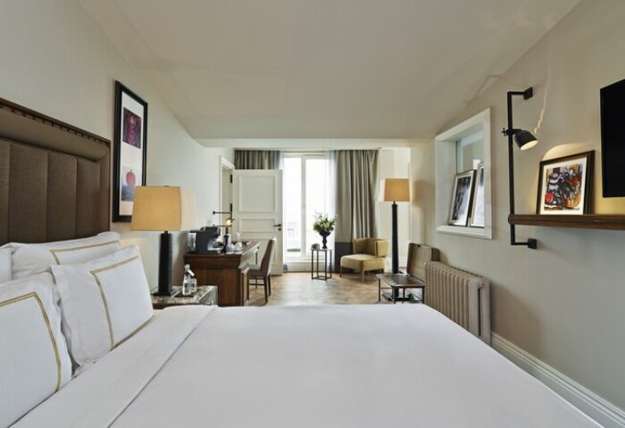 The Bank Hotel Istanbul room. Gay-friendly Design Hotel™ features a bed, desk, and balcony. Ideal for gay travel, offering a stylish stay.