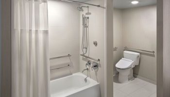 Hyatt Regency Waikiki Beach Resort & Spa gay-friendly hotel bathroom. Accessible bathtub, shower, and toilet with grab bars.