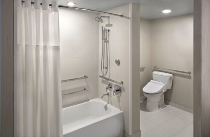 Hyatt Regency Waikiki Beach Resort & Spa gay-friendly hotel bathroom. Accessible bathtub, shower, and toilet with grab bars.