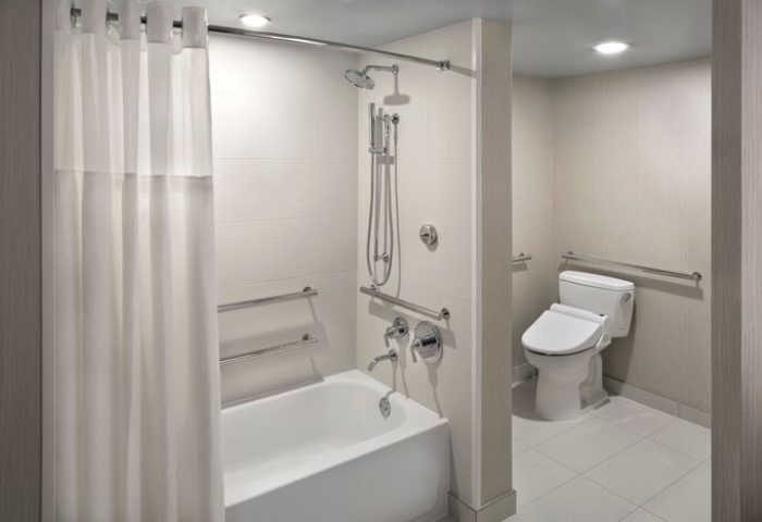 Hyatt Regency Waikiki Beach Resort & Spa gay-friendly hotel bathroom. Accessible bathtub, shower, and toilet with grab bars.