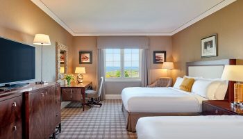 Fairmont St Andrews, Scotland: Gay-friendly hotel room with two beds, desk, TV, and a view. Ideal for gay men seeking luxury travel advice.