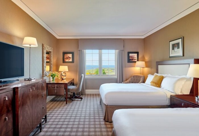 Fairmont St Andrews, Scotland: Gay-friendly hotel room with two beds, desk, TV, and a view. Ideal for gay men seeking luxury travel advice.