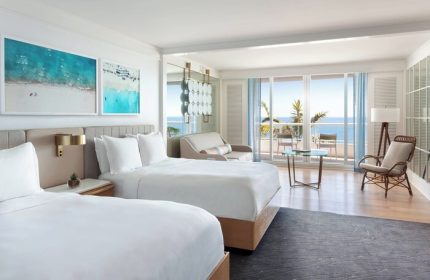 Ritz-Carlton, Fort Lauderdale, gay-friendly hotel room. Two beds, ocean view, balcony, seating area. Luxury travel for gay men. Coastal decor.