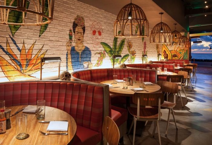 W Fort Lauderdale gay-friendly hotel: El Vez restaurant interior. Round booths, Frida Kahlo mural, skull decor, and ocean view. Stylish dining.