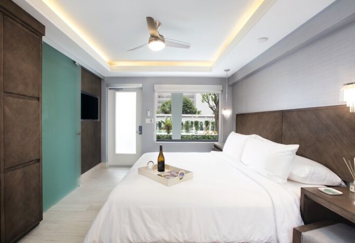 Elita Hotel room: Gay-friendly hotel with king bed, wine, ceiling fan, and modern decor. A great choice for gay men's travel and relaxation.
