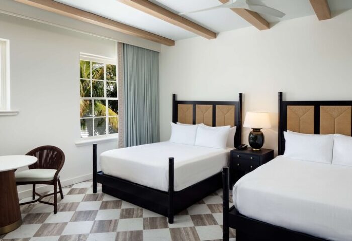 Casa Marina Key West, Curio Collection by Hilton: Gay-friendly hotel room with two beds, table, chair, and a view of palm trees.