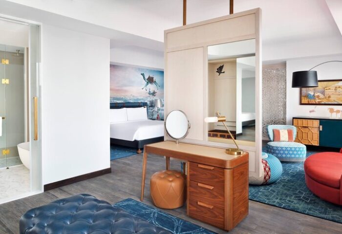 Hotel Indigo Dubai Downtown gay-friendly room. Modern design with desert mural, vanity, and colorful accents. Ideal for gay travel in Dubai.