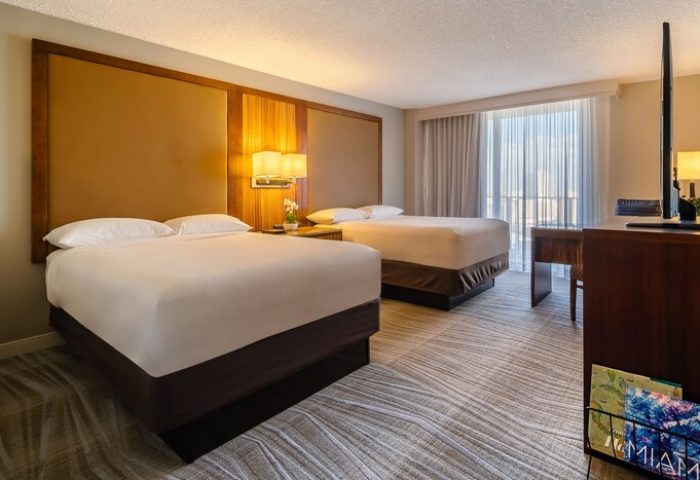 Hyatt Regency Miami gay-friendly hotel room with two beds, desk, TV, and balcony. A comfortable stay for LGBTQ+ travelers in Miami.