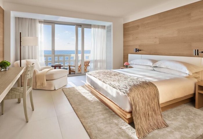 Miami Beach EDITION gay-friendly hotel room. Ocean view suite with king bed, desk, and balcony. Modern, bright, and luxurious accommodations.