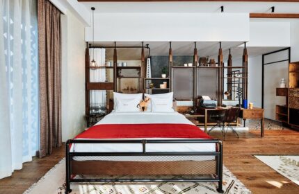 25hours Hotel One Central gay-friendly room. Stylish design with bed, desk, and shelving. Ideal for gay men's travel, comfort, and style.