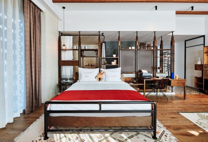 25hours Hotel One Central gay-friendly room. Stylish design with bed, desk, and shelving. Ideal for gay men's travel, comfort, and style.