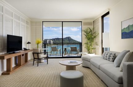 Halekulani Hotel's gay-friendly room with Diamond Head view. Balcony, seating, and elegant interior design. A luxury experience for gay travelers.