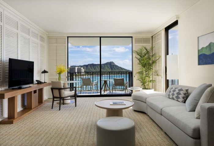 Halekulani Hotel's gay-friendly room with Diamond Head view. Balcony, seating, and elegant interior design. A luxury experience for gay travelers.