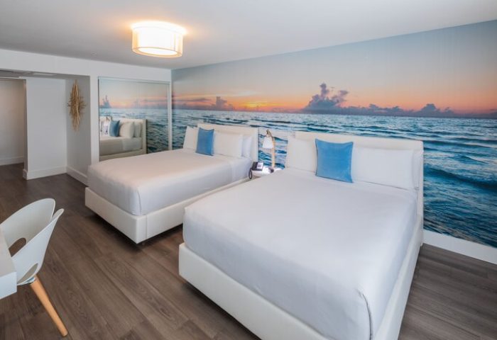 President Hotel gay-friendly room with two beds, ocean view wallpaper. Modern design, bright space. Perfect for gay travel, vacation.