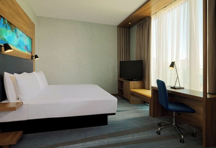 Aloft Palm Jumeirah hotel room. Modern decor, bed, desk, & TV. Gay-friendly hotel for gay men travel. Comfortable & stylish.