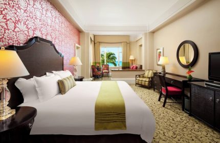 The Royal Hawaiian, a Luxury Collection Resort, Waikiki gay-friendly hotel room. Ocean view, stylish decor, and comfortable bed.
