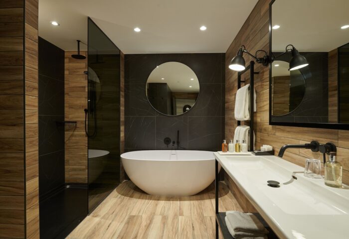 Cameron House on Loch Lomond gay-friendly hotel bathroom. Features a modern tub, shower, and sink. Perfect for gay men's travel in Scotland.