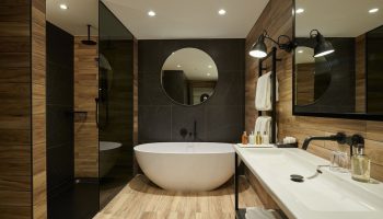 Cameron House on Loch Lomond gay-friendly hotel bathroom. Features a modern tub, shower, and sink. Perfect for gay men's travel in Scotland.