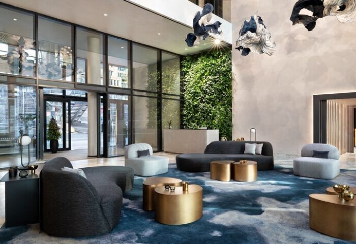 The Westin London City lobby. Gay-friendly hotel interior with modern seating, green wall, and stylish decor. A luxurious and welcoming space.