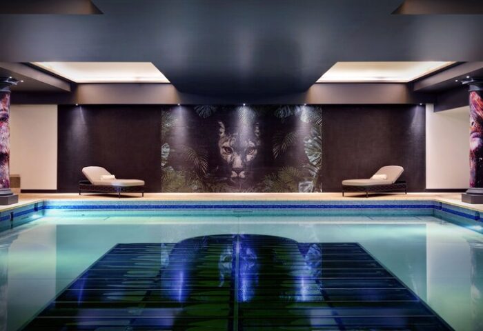 NYX Hotel London Holborn pool. Gay-friendly hotel with a unique design. Relaxing space with a jaguar mural. Leonardo Hotels.
