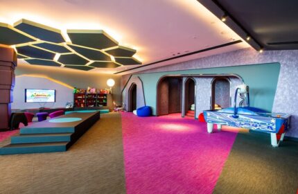 W Dubai - The Palm, gay-friendly hotel kids' club. Play area with air hockey, TV, toys, and colorful decor. A fun space for children.