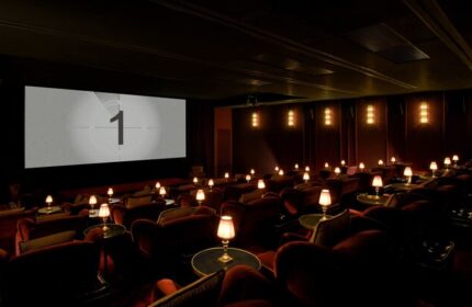 Soho House Istanbul's cinema. Gay-friendly hotel offers luxury with plush seating, individual lamps, and a classic countdown screen.