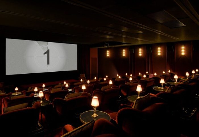 Soho House Istanbul's cinema. Gay-friendly hotel offers luxury with plush seating, individual lamps, and a classic countdown screen.