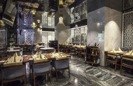 The Elysium Taksim Hotel's gay-friendly restaurant. Upscale dining area with set tables, mirrored ceiling, and marble accents. Ideal for gay travel.