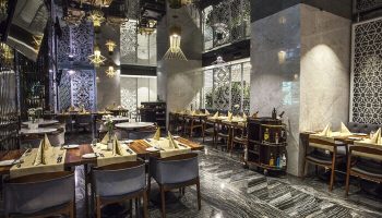 The Elysium Taksim Hotel's gay-friendly restaurant. Upscale dining area with set tables, mirrored ceiling, and marble accents. Ideal for gay travel.