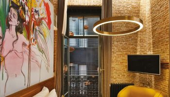 Hotel The Public special category, gay-friendly hotel room. Balcony view, exposed brick, modern art, & stylish decor. Ideal for gay travel.