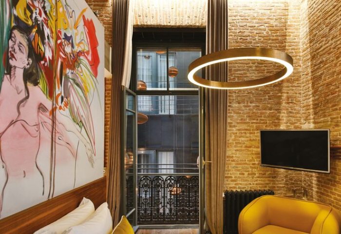 Hotel The Public special category, gay-friendly hotel room. Balcony view, exposed brick, modern art, & stylish decor. Ideal for gay travel.