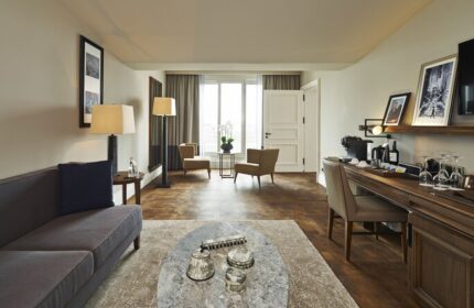 The Bank Hotel Istanbul room. Design Hotels™ member, gay-friendly. Stylish interior with sofa, chairs, desk, and Istanbul view.