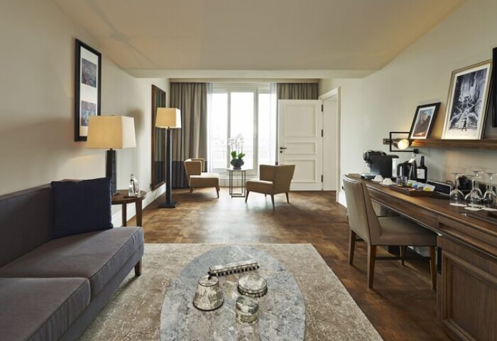 The Bank Hotel Istanbul room. Design Hotels™ member, gay-friendly. Stylish interior with sofa, chairs, desk, and Istanbul view.