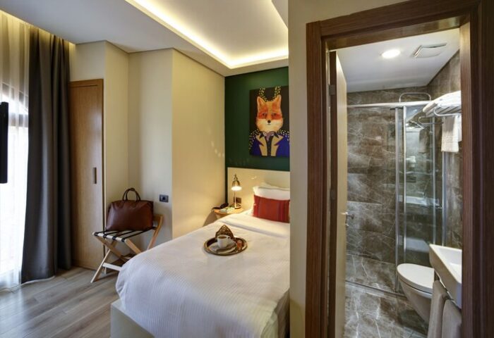 The Fox Hotel: Gay-friendly hotel room. Single bed, fox art, and bathroom with shower. Ideal for gay men's travel. Boutique hotel.