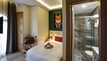 The Fox Hotel: Gay-friendly hotel room. Single bed, fox art, and bathroom with shower. Ideal for gay men's travel. Boutique hotel.
