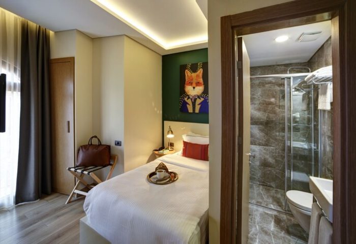 The Fox Hotel: Gay-friendly hotel room. Single bed, fox art, and bathroom with shower. Ideal for gay men's travel. Boutique hotel.