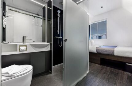 The Z Hotel Trafalgar gay-friendly hotel room. Modern design with shower, sink, and toilet. A compact yet stylish space for gay travelers.