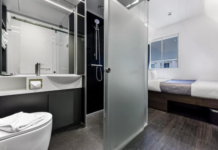 The Z Hotel Trafalgar gay-friendly hotel room. Modern design with shower, sink, and toilet. A compact yet stylish space for gay travelers.
