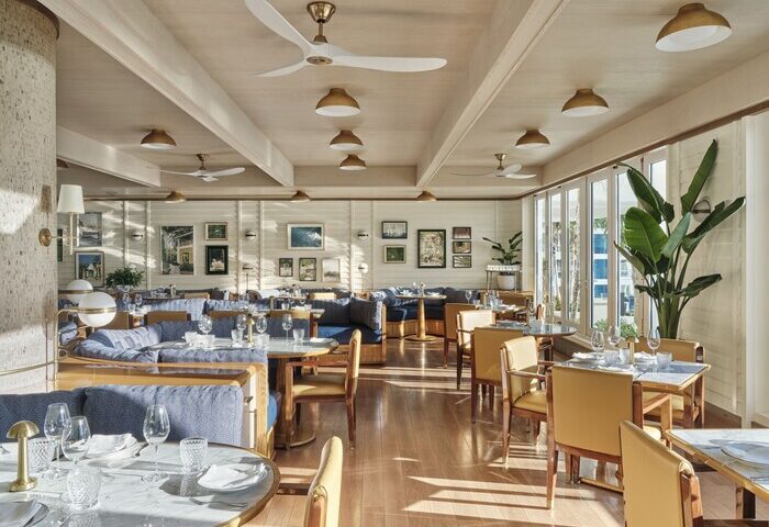 Four Seasons Hotel Fort Lauderdale dining area. Gay-friendly hotel with tables, chairs, and couches. Restaurant's interior decor.
