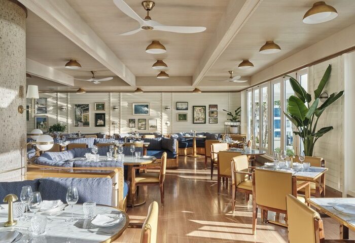 Four Seasons Hotel Fort Lauderdale dining area. Gay-friendly hotel with tables, chairs, and couches. Restaurant's interior decor.