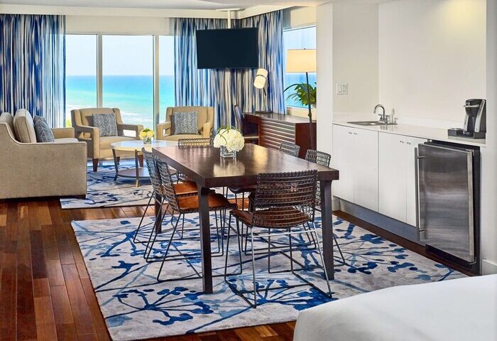 Sonesta Fort Lauderdale Beach gay-friendly hotel suite. Ocean view, dining table, and kitchenette. Perfect for gay travelers.